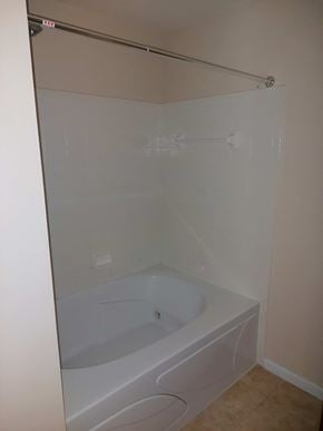 Mason apartment for rent - A white bathroom with a tub and a towel rack.