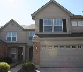 Mason apartment for rent - A house with a garage door and a brick pillar.