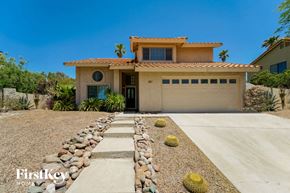 Tucson house for rent - a house with a driveway and a garage door