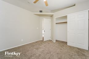 Tucson house for rent - a bedroom with two closets and a ceiling fan