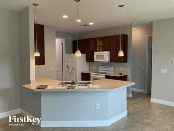 Lehigh Acres house for rent - a kitchen with a sink and a counter top