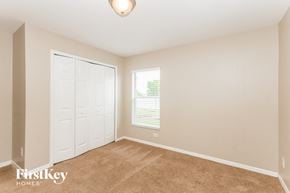 Cape Coral house for rent - a bedroom with a closet and a door and a window