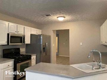 Sugar Hill house for rent - a kitchen with a sink a stove and a refrigerator