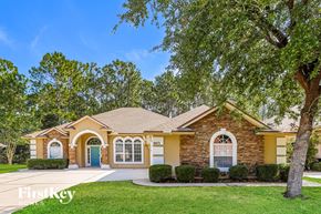 Jacksonville house for rent - a home with a large tree in front of it