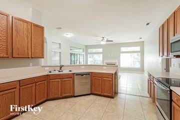 Jacksonville house for rent - a large kitchen with wooden cabinets and a stainless steel dishwasher