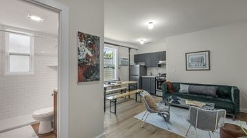 Detroit apartment for rent - an open living room and kitchen with a couch and a table