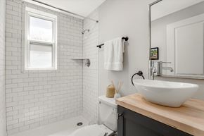 Detroit apartment for rent - a white bathroom with a sink and a shower