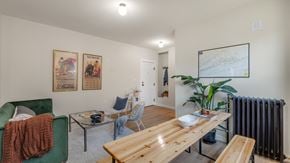 Detroit apartment for rent - a living room with a wooden dining table and a radiator