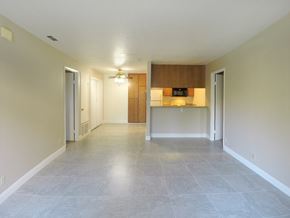 Modesto apartment for rent - A spacious room with a ceiling fan and a light switch.