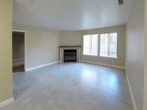 Modesto apartment for rent - A spacious living room with a fireplace and a television.