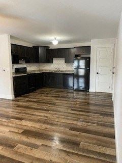 New Minas apartment for rent - a kitchen with black cabinets and a wooden floor