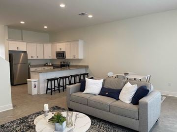 Youngsville apartment for rent - a living room and kitchen with a couch and a table