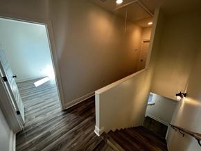 Youngsville apartment for rent - a view from the top of a staircase in a home with wood floors