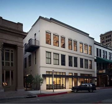 Baton Rouge apartment for rent - A white building with a black car parked in front of it.