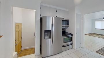 Wheat Ridge house for rent - a kitchen with a stainless steel refrigerator and microwave