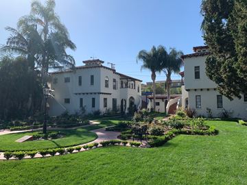 Fullerton apartment for rent - a mansion with a garden and palm trees in front of it