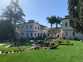 Fullerton apartment for rent - a mansion with a garden and palm trees in front of it