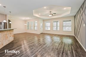 Dayton house for rent - A spacious room with wooden floors and a ceiling fan.