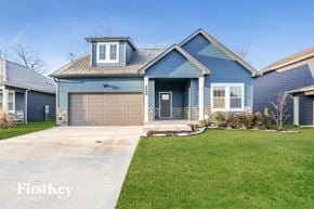 Clarksville house for rent - a blue house with a driveway and a garage door