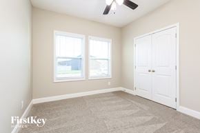 Clarksville house for rent - a bedroom with a carpeted floor and two windows