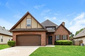 Gardendale house for rent - A brick house with a garage door and a black door.