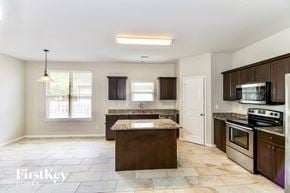 Gardendale house for rent - A kitchen with a granite countertop and stainless steel appliances.