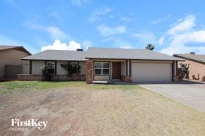 Phoenix house for rent - a house with a driveway and a garage door