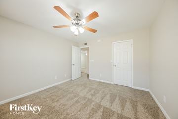Phoenix house for rent - a spacious living room with carpet and a ceiling fan