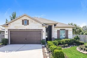 Splendora house for rent - A house with a brown garage door and a brown window.