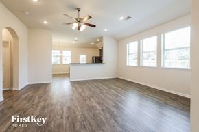 Splendora house for rent - A spacious room with a ceiling fan and wooden flooring.