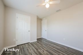 Cape Coral house for rent - a bedroom with a white door and a ceiling fan