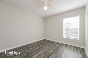 Cape Coral house for rent - the spacious living room with wood flooring and a ceiling fan