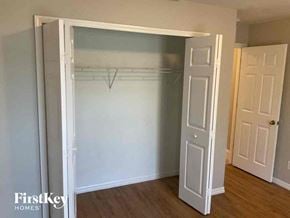 Cape Coral house for rent - an empty bedroom with a closet and a door open to a closet with a white