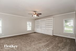 Acworth house for rent - an empty living room with a ceiling fan and white shelves