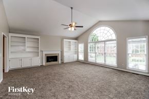 Acworth house for rent - an empty living room with a large window and a ceiling fan