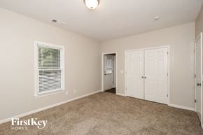 Acworth house for rent - a bedroom with a carpeted floor and white doors