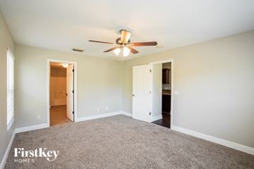 North Port house for rent - a living room with carpet and a ceiling fan
