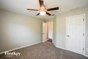 North Port house for rent - a bedroom with a ceiling fan and a door to a closet