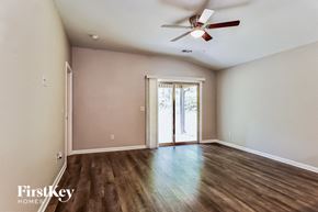 Kimberly house for rent - A room with a ceiling fan and sliding glass doors.