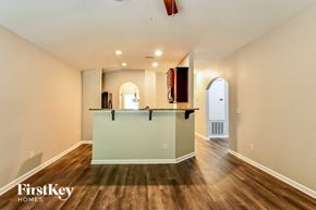 Kimberly house for rent - A spacious room with a wooden floor and a bar area.