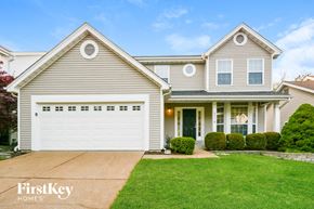 Ballwin house for rent - a house with a white garage door and a lawn