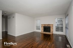 Ballwin house for rent - a living room with wood floors and a fireplace