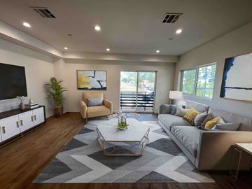 North Hollywood apartment for rent - a large living room with a couch and a table