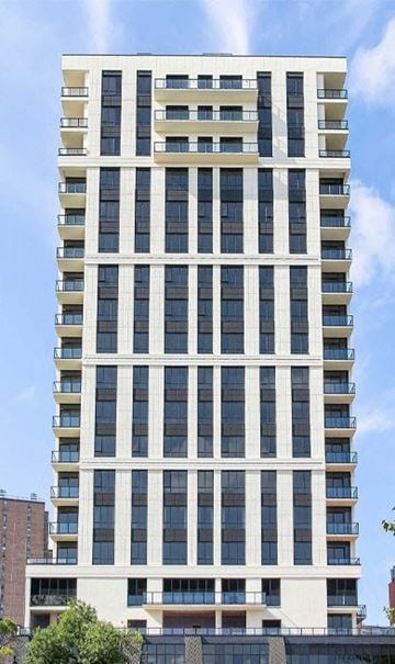 Brooklyn apartment for rent - a tall building with many windows and a blue sky