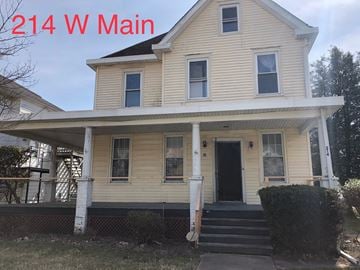 Elkton apartment for rent - A two-story house with a porch and a front door.