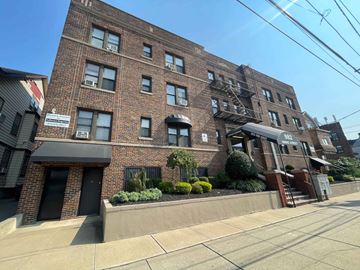 Irvington apartment for rent - A brick building with a black awning and a sign that reads "322" is in front of a clear blue sky.