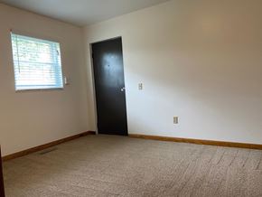 Hartville apartment for rent - an empty room with a black door and a window