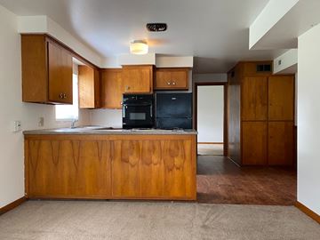 Hartville apartment for rent - an empty kitchen with wooden cabinets and a counter