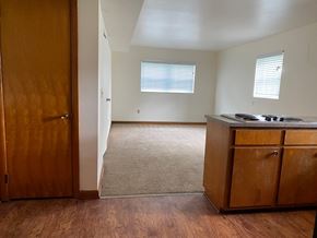 Hartville apartment for rent - an empty kitchen and living room with a stove and cabinets