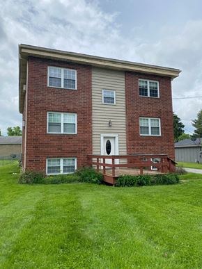 Hartville apartment for rent - a brick house with a wooden deck in front of it